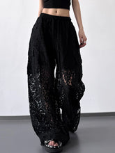 Black lace wide leg pants with a drawstring waist and flowing sheer fabric for elegant wear
