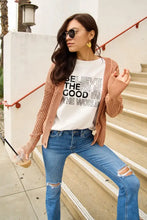 Peach knit cardigan with ribbed cuffs over Simply Love world short sleeve t-shirt