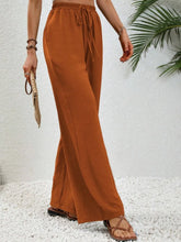 Cinnamon-colored wide leg drawstring pants with elastic waistband in loose-fitting comfortable fabric