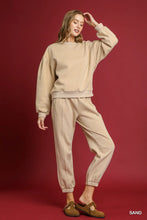 Beige oversized sweatshirt paired with umgee fleece jogger pants featuring a drawstring waist allows relaxed comfort