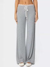 Gray lace trim wide leg pants featuring delicate lace trim at the waistband and white drawstrings for lounging comfort