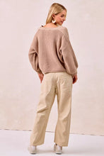 A cozy beige ribbed knit sweater with loose balloon sleeves paired with bi bi drawstring striped twill barrel pants