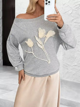 Gray floral applique off-the-shoulder sweatshirt with a white tulip design, slightly stretchy, machine wash cold