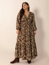 Long-sleeved balloon sleeve maxi dress in olive green floral print with cinched waist and tiered skirt