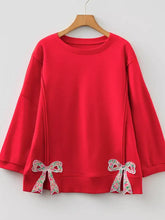 Red long-sleeved baggy sweatshirt with floral bow patched hem and exposed seam details machine wash cold recommended