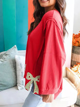 Red long-sleeved floral bow patched baggy sweatshirt with glittery gold bow detail at hem machine wash cold