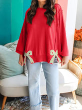 Red oversized sweater with gold sequined floral bow details at hem machine wash cold recommended