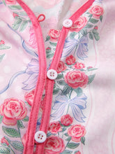 Pink floral collared ruffled half sleeve shirt with white buttons and matching pink trim featuring lavender floral pattern