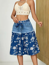 Blue floral denim skirt with denim waistband and tie detail featuring frayed hem detail
