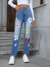 Light-wash denim high waist distressed jeans with colorful pink white yellow and red floral embroidery