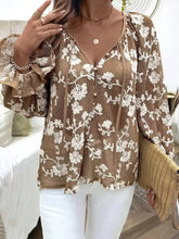 A brown long sleeve shirt with white floral embroidered lace and ruffled sleeves floral embroidered long sleeve shirt