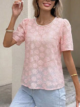 A delicate pink floral embroidered lace blouse with puffed short sleeves and pearl trim at the round neckline