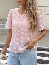 Pink floral embroidered lace blouse with pearl trim, short puffed sleeves, and round neckline
