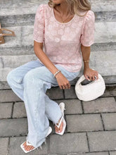 White woven handbag with rounded top handle and textured surface paired with floral embroidered pearl trim blouse