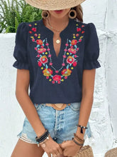 Navy blue floral embroidered puff sleeve blouse with vibrant red orange and yellow embroidery across neckline