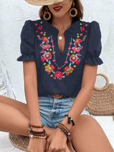Navy blue short-sleeved blouse with colorful floral embroidered puff sleeves and ruffle detailing