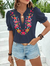 Navy blue short-sleeved blouse with colorful floral embroidered puff sleeves and neckline detailing