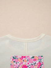 Off-white floral half sleeve oversized blouse with sheer overlay and vibrant pink floral patch on the back