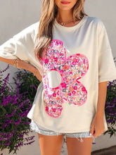 Off-white half sleeve oversized t-shirt with vibrant floral appliqué and pink trim in floral half sleeve design