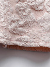 Delicate pink floral jacquard peplum tank with raised lace floral patterns and softly textured embroidered finish