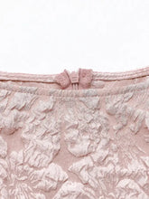 Delicate pink floral jacquard peplum tank with lace texture and matching zipper closure