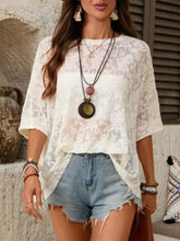 White floral lace sheer top with short sleeves and relaxed fit featuring a round neck design
