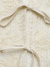 Cream-colored floral lace tie-front shirt with intricate lace tie bodice and matching satin ribbon ties