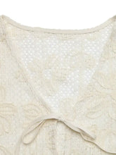 Cream-colored floral lace tie-front shirt featuring delicate floral lace patterns and a soft tie at the neckline