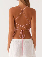 Delicate pink floral lace neck cami with a lace-up crisscross back and tied bow at the waist visible from the back