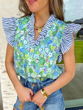 A vibrant green and blue floral neck blouse with striped patchwork flutter sleeve and ruffled shoulders