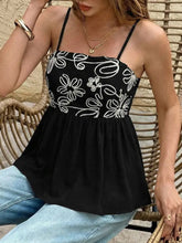 Black embroidered floral peplum cami top with thin straps and a ruffled hem in delicate fabric