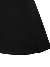 Black fabric skirt with smooth textured surface and stitched hem paired with a floral peplum cami top