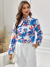 Floral print blouse with tie neck and long sleeve length on white background