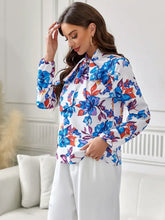 Floral print blouse with ruffled long sleeve length and tie neck on white background