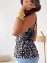 Black and white floral print button-down cami with spaghetti straps and ruffled back detail visible from the back side