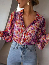 Floral print button up shirt with puffy sleeves in vibrant purple orange and pink on light base fabric