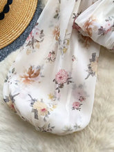 A delicate white chiffon floral print balloon sleeve blouse with soft flowing fabric in pink peach and muted green tones