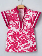 A vibrant pink floral print blouse with v-neckline, flutter sleeves, and delicate lace trim on collar and sleeve edges