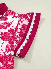 A vibrant red and white floral print blouse with flutter sleeve and delicate lace trim along the sleeve edge