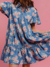 Blue denim floral print mini dress with pink rose pattern and tiered ruffle hem in print denim fabric