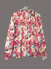 Long-sleeved floral print frill trim blouse in pink peach and mint green on a light background for elegant wear