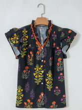 Black floral print short sleeve shirt with frilled v neck and orange-trimmed neck short sleeve detailing