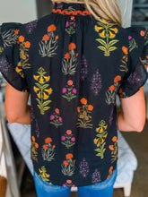 Black floral print short sleeve shirt with frilled v neck and orange crocheted lace trim neckline