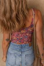 Floral print mesh bodysuit in stretchy polyester blend with high-waisted jeans