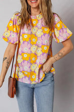 Floral print puff sleeve blouse with bold yellow and pink flowers on lavender background featuring ruffled neckline