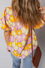 Floral print puff sleeve blouse with bold yellow and pink flowers on lavender background and puffed short sleeves