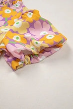 A vibrant floral print puff sleeve blouse in soft pink yellow and purple with ruffled trim for children