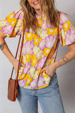 Floral print puff blouse with puffed short sleeves and ruffled neckline featuring yellow flowers on pink lavender background