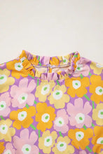 A vibrant purple floral print puff blouse with bold yellow and pink blossoms and ruffled neckline trim