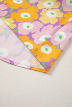 Floral print puff sleeve blouse in vibrant purple and yellow floral pattern on soft lightweight fabric inspired by marimekko